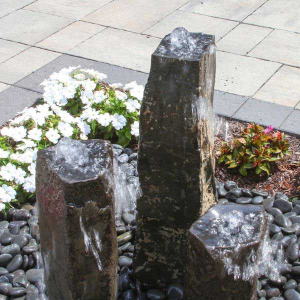 Bowled Top Basalt Fountain Kit on black pebbles in action