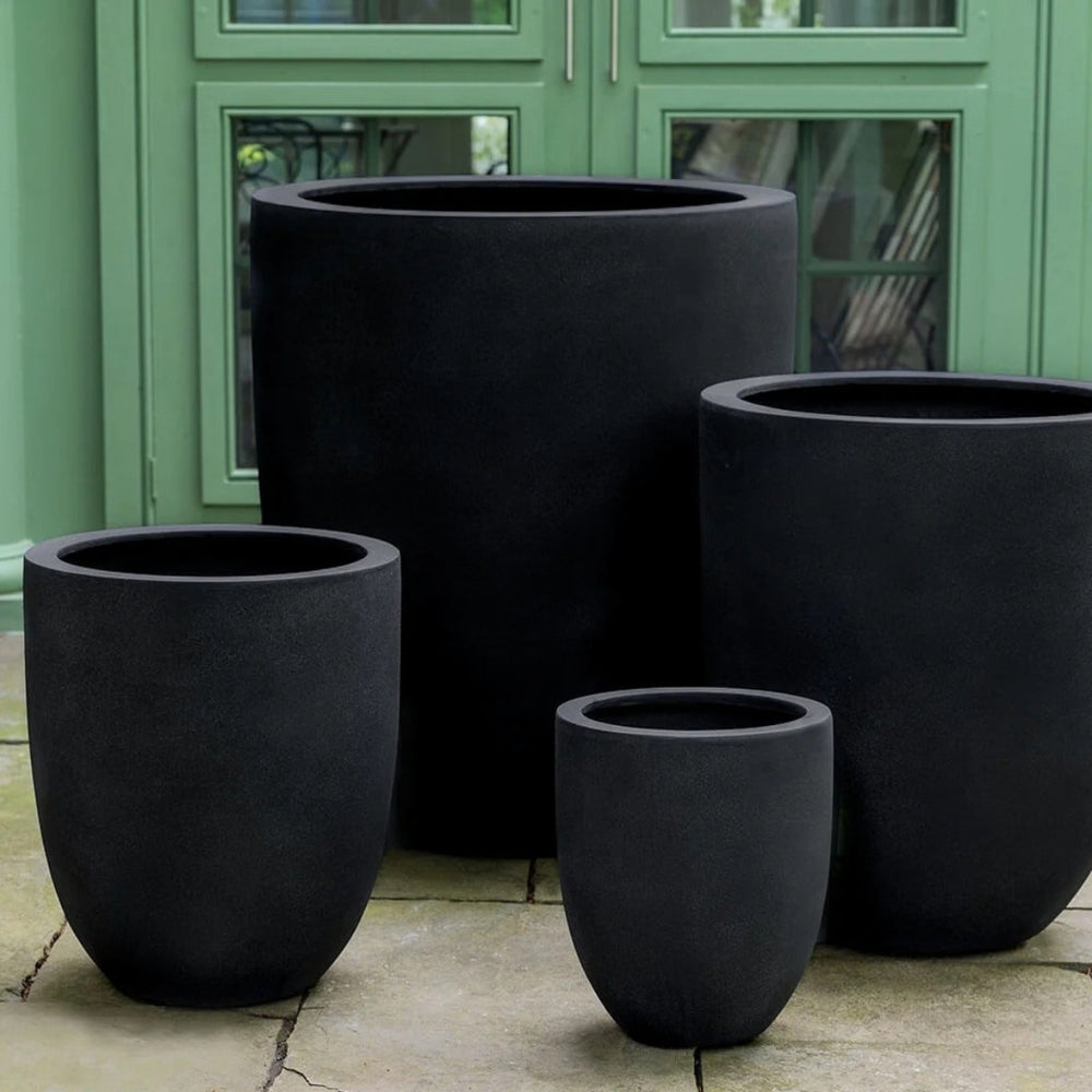 Bradford Planter in onyx black lite on concrete against green door.
