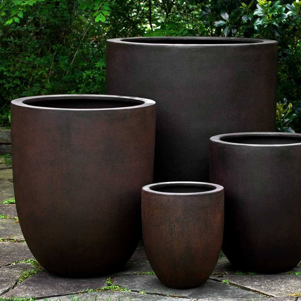 Bradford Planter in rust lite on concrete in the backyard.