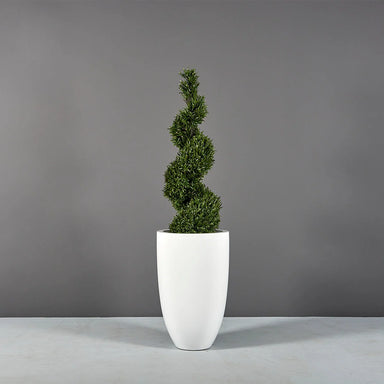 Brannan Tapered Round Fiberglass Planter on concrete filled with plants.