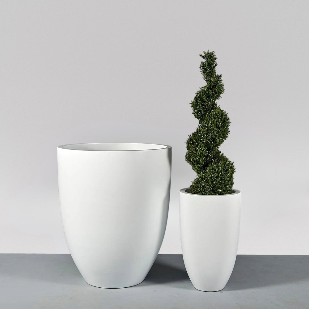 Brannan Tapered Round Fiberglass Planter shown with different sizes filled with plants.