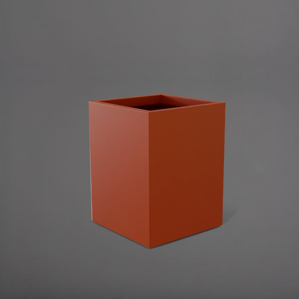Brisane Tall Corner Fiberglass Planter in matte terra cotta against gray background.