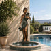 Bronze Antonia with Jars Fountain sculpture in action near swimming pool.