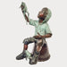 Bronze Boy on bucket with frog sculpture against gray background