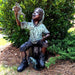 Bronze Boy on bucket with frog sculpture in the backyard