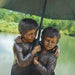 Bronze children holding umbrella fountain upclose