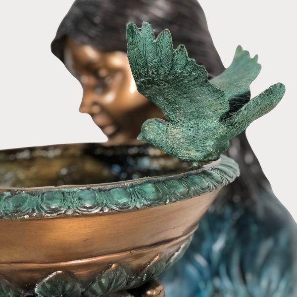 Bronze Girl with birdbath fountain sculpture sideview upclose