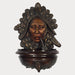 Bronze Indian with pipe wall fountain against gray background