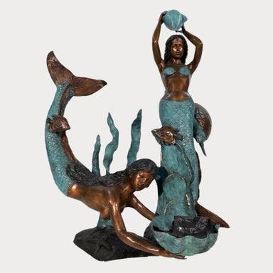 Bronze Mermaids in sea fountain sculpture against white backdrop