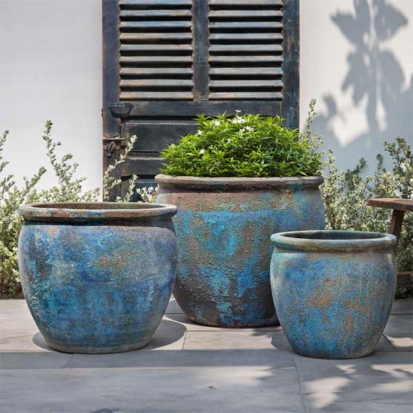 Calvados Planter - Blue Verdigris - S/3 on concrete filled with plants