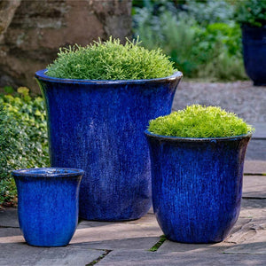 Campana Planter - Riviera Blue - S/3 on concrete filled with plants