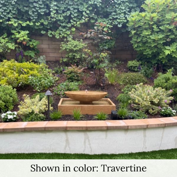 Campania Recife Fountain in action in garden bed.
