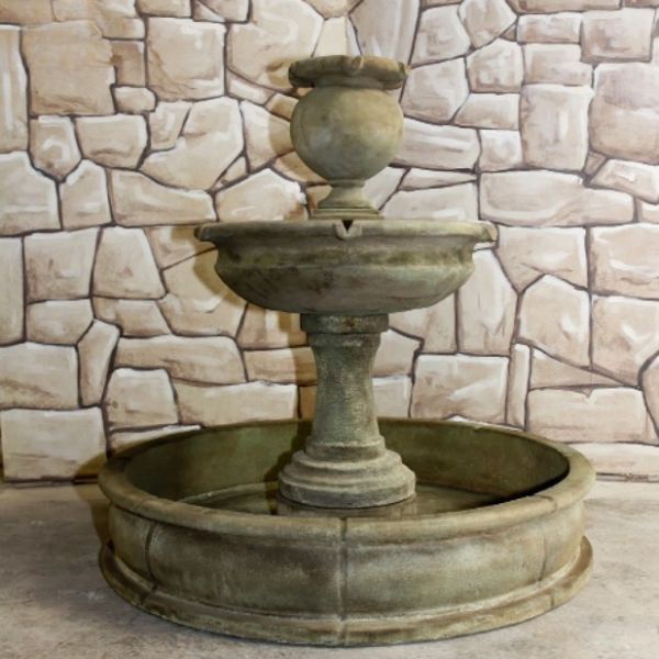 Cannes Pond Fountain against bricks wall.