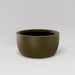 Casablanca Bowl Fiberglass Planter in matte bronze against gray background.