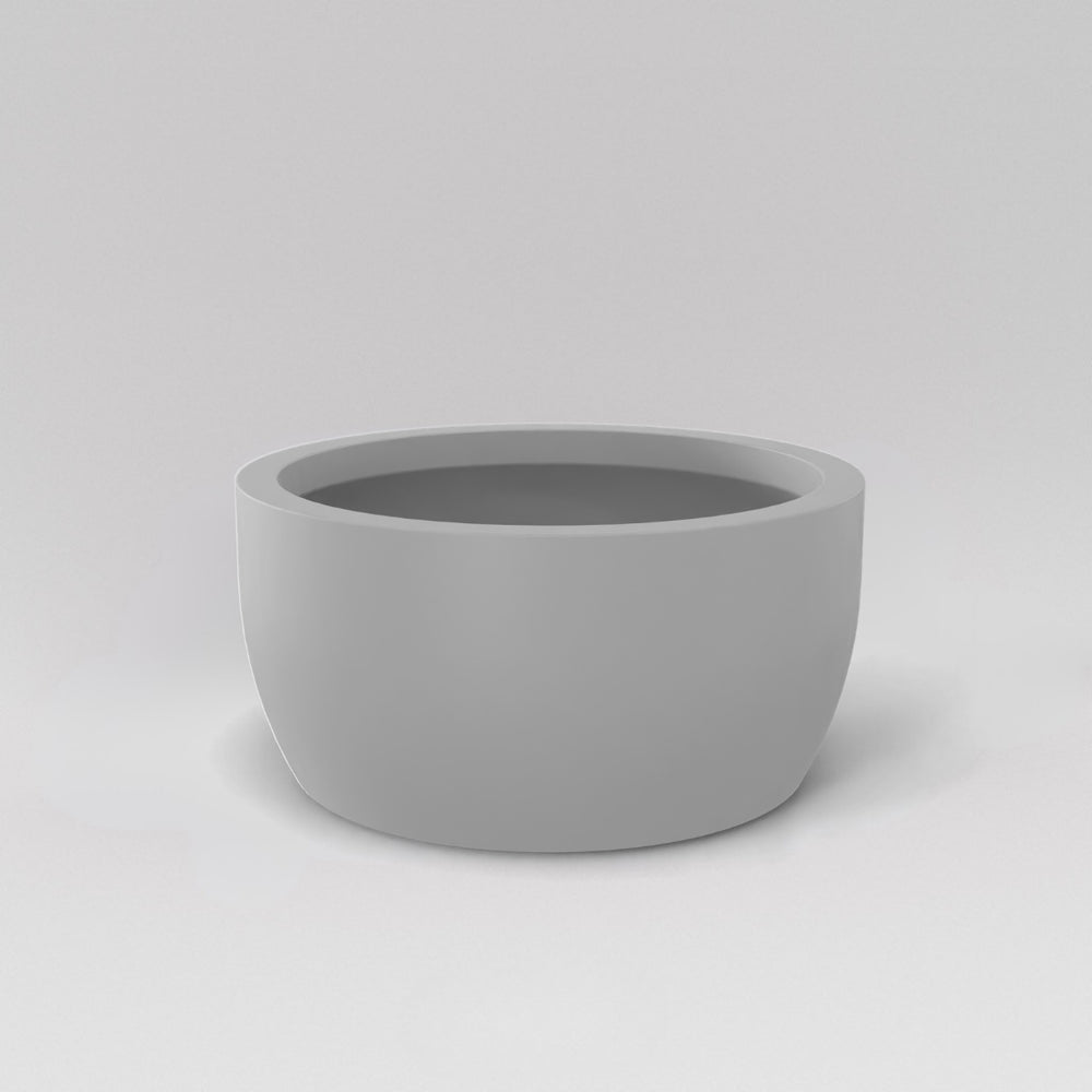 Casablanca Bowl Fiberglass Planter in matte cement grey against gray background.