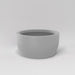 Casablanca Bowl Fiberglass Planter in matte cement grey against gray background.