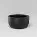Casablanca Bowl Fiberglass Planter in matte charcoal against gray background.