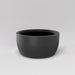 Casablanca Bowl Fiberglass Planter in matte gunmetal against gray background.