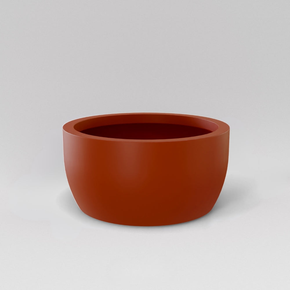 Casablanca Bowl Fiberglass Planter in matte terra cotta against gray background.