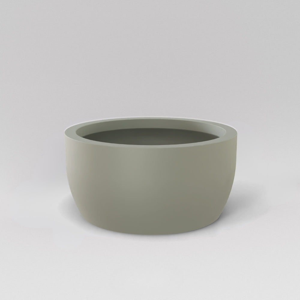Casablanca Bowl Fiberglass Planter in satin beige against gray background.