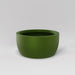 Casablanca Bowl Fiberglass Planter in satin green against gray background.