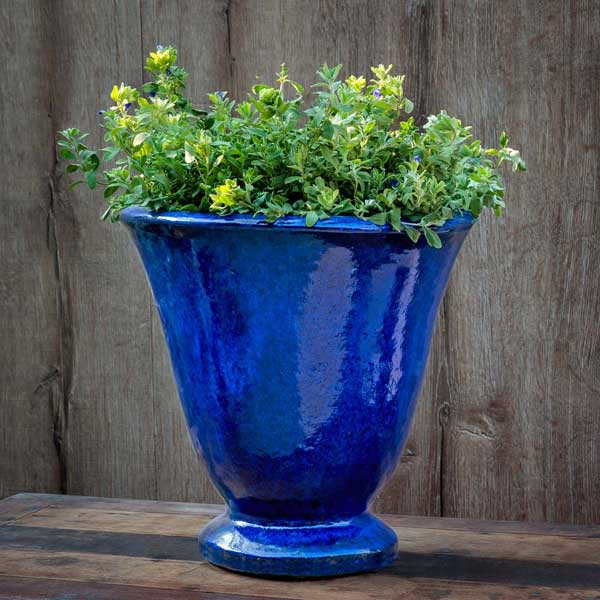 Caterine Urn Planter - Riviera Blue - S/1 on table filled with plants