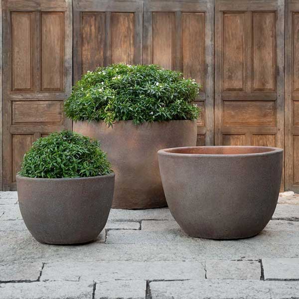 Catinat Planter - Sandblasted - S/3 filled with plants in the backyard