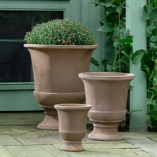 Chaon Urn Planter - Brown Terra Cotta - S/3 on concrete filled with plants