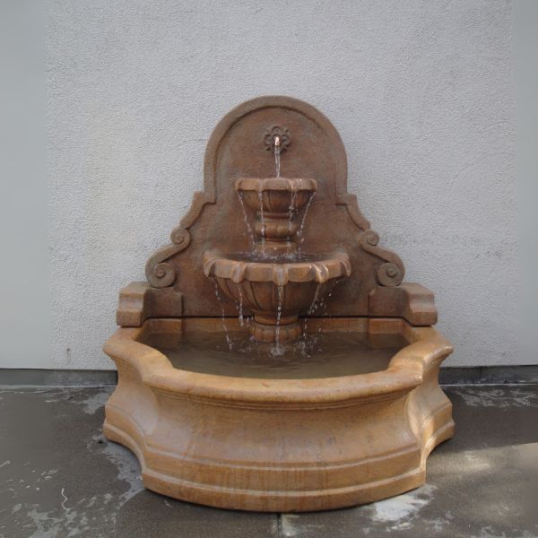 Chateau Wall Fountain in action against concrete wall.