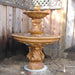Chelsea Garden Fountain with step in action beside wooden fence.