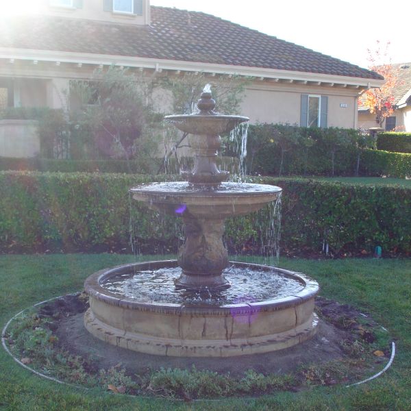 Chelsea Garden Fountain with Step in the backyard against the house.