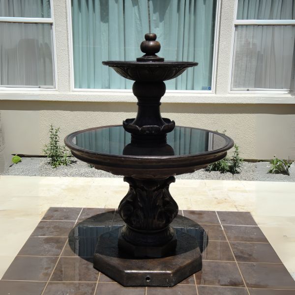 Chelsea Garden Fountain with Step  on concrete against the house window.