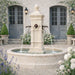 Close Up View of the Aquitaine Pond Fountain in cast stone with four rustic iron spouts and flowing water.