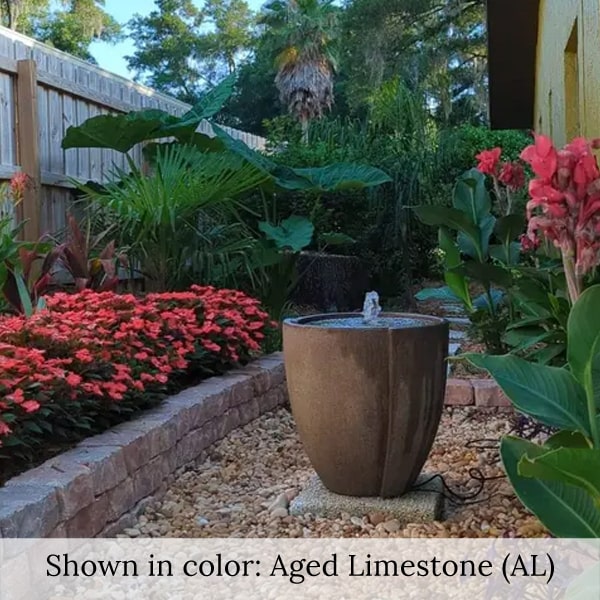 Concept Basin Fountain on gravel beside red flowers