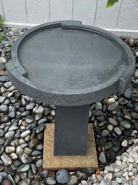 Concept Birdbath Small on rocks in the backyard upclose