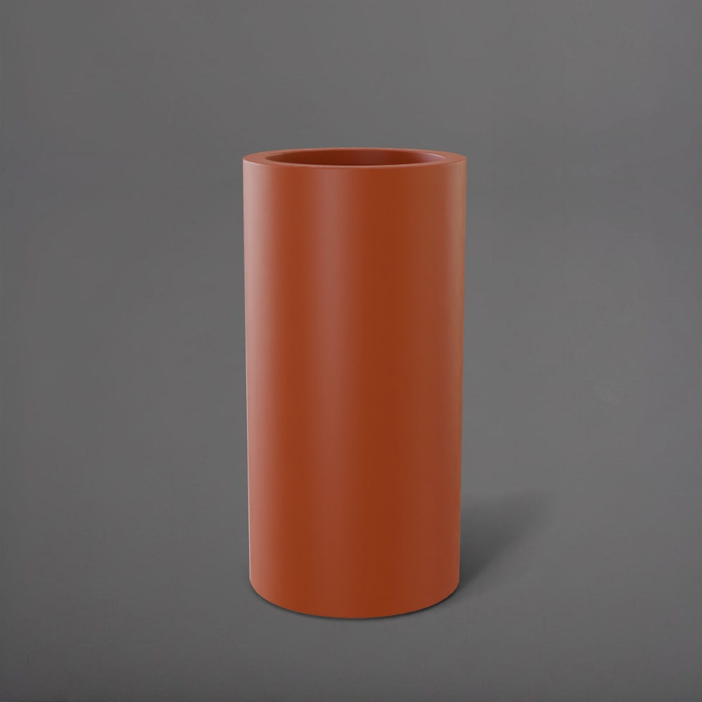 Corry Tall Cylinder Fiberglass Planter in matte terra cotta against gray background. 