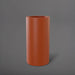 Corry Tall Cylinder Fiberglass Planter in matte terra cotta against gray background. 