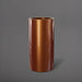Corry Tall Cylinder Fiberglass Planter in metallic bronze against gray background. 