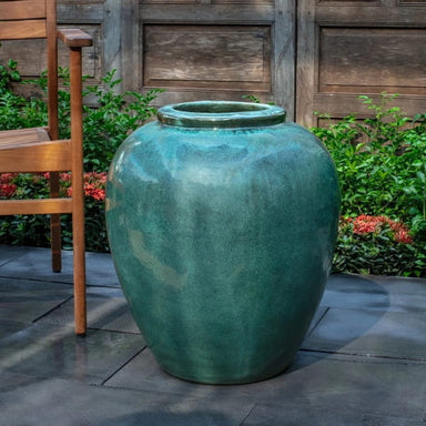 Corsica Jar Antique Jade on concrete in the backyard.