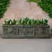 Crittenden Planter on concrete filled with plants.