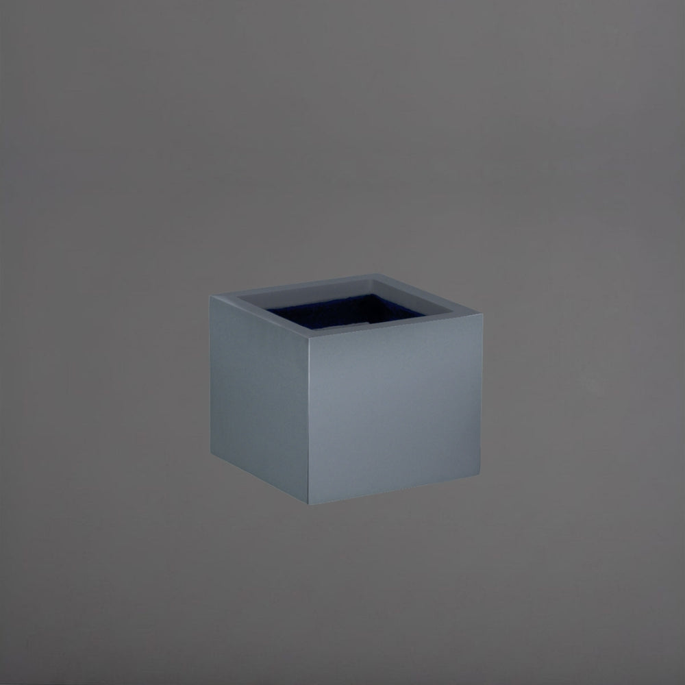 Cuba Low Corner Fiberglass Planter in matte charcoal against gray background.