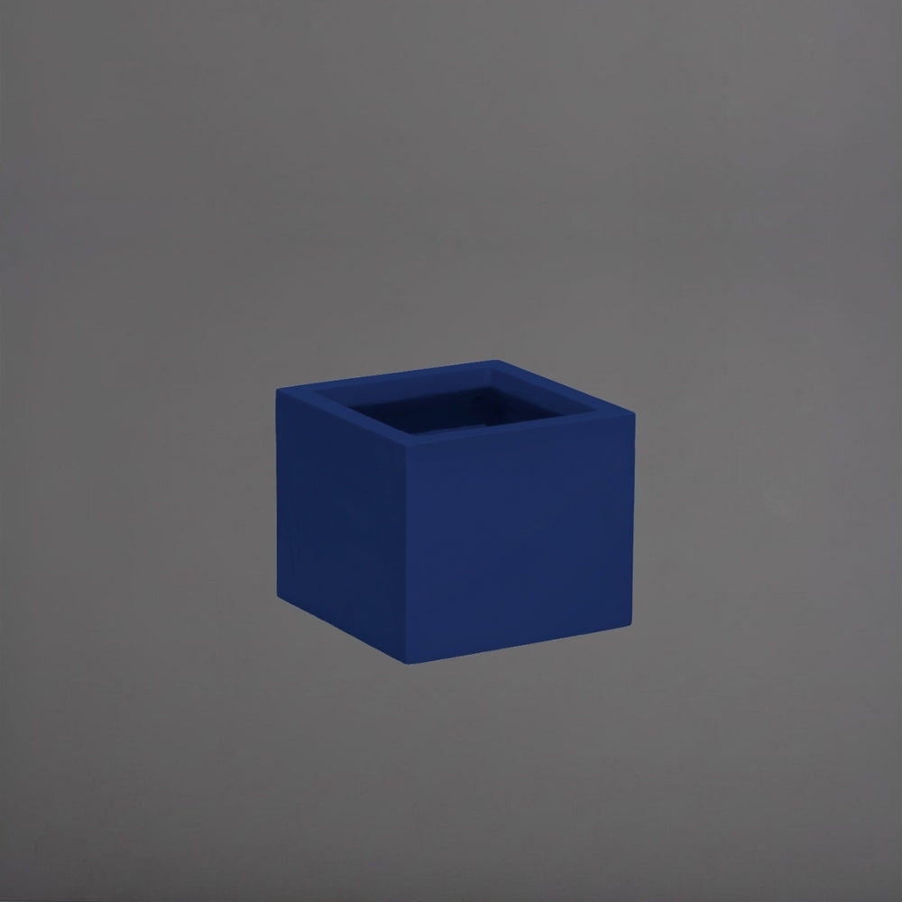 Cuba Low Corner Fiberglass Planter in matte cobalt blue against gray background.