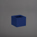 Cuba Low Corner Fiberglass Planter in matte cobalt blue against gray background.