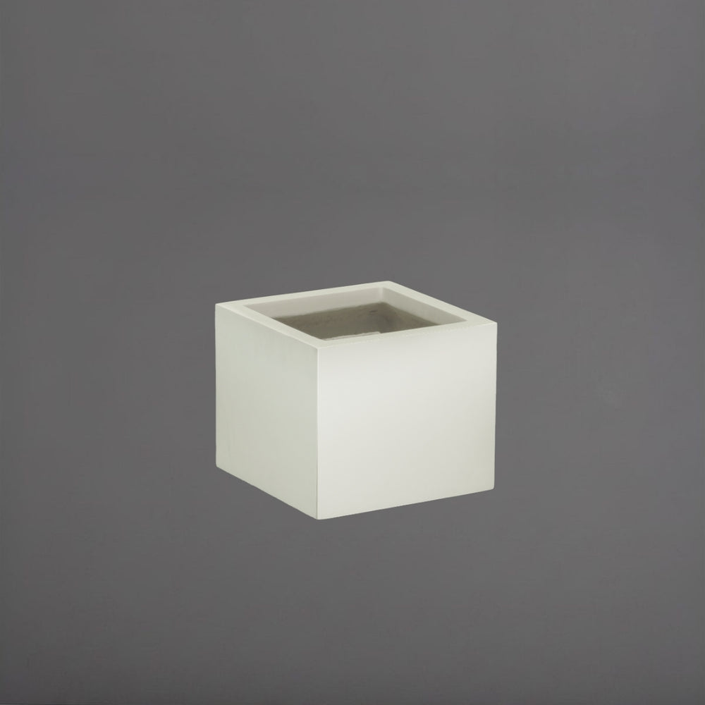 Cuba Low Corner Fiberglass Planter in satin beige against gray background.