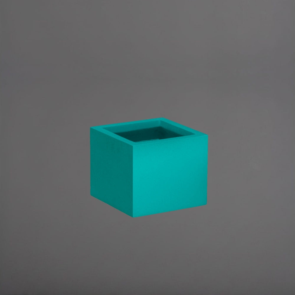 Cuba Low Corner Fiberglass Planter in satin seafoam against gray background.