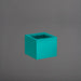 Cuba Low Corner Fiberglass Planter in satin seafoam against gray background.
