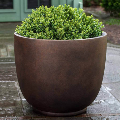 Danilo Planter, Extra Large in rust lite filled with plants.