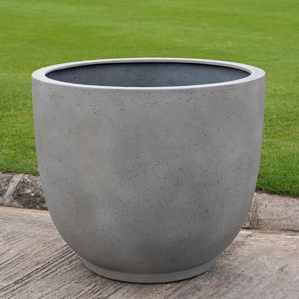 Danilo Planter, Small in stone grey lite on concrete in the backyard.