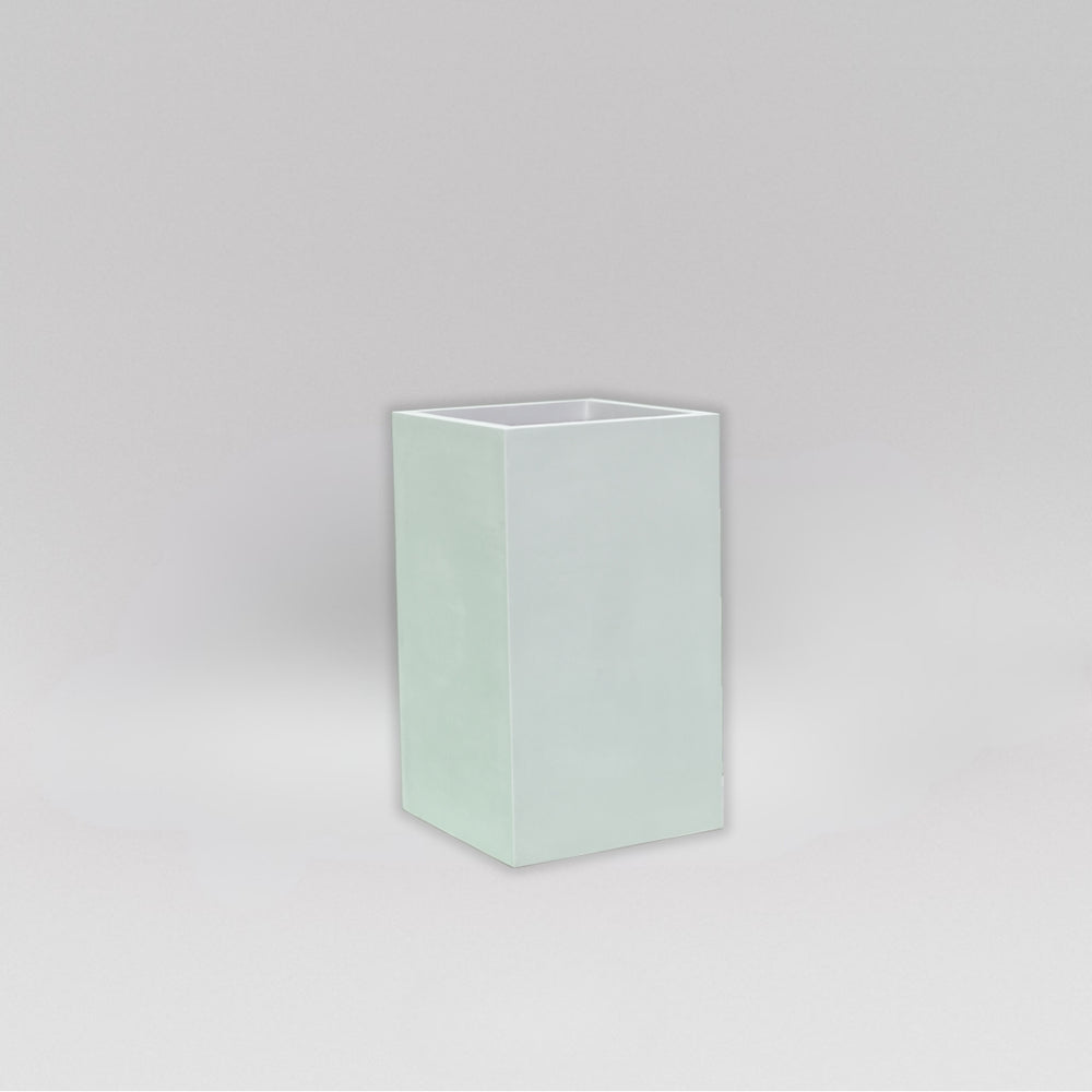 Darwin Tall Corner Fiberglass Planter in matte bright white against gray background.