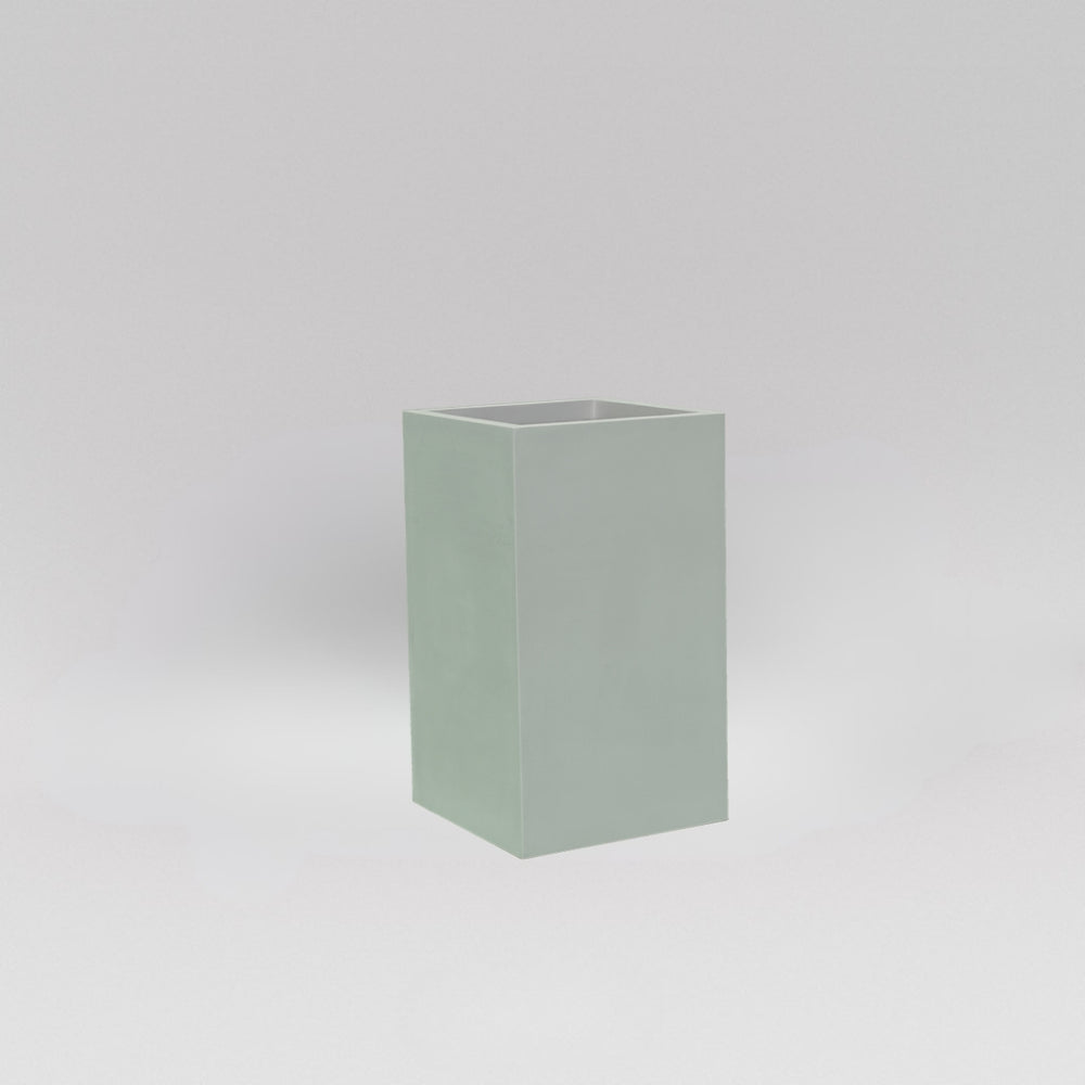 Darwin Tall Corner Fiberglass Planter in matte cement grey against gray background.